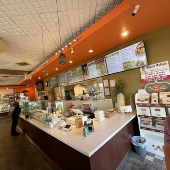 Tarbosh Mediterranean Restaurant - a man standing at a counter in a restaurant - Mediterranean Near Me - El Cajon, California Tarbosh Mediterranean Restaurant - a man standing at a counter in a restaurant - Mediterranean Near Me - El Cajon, California