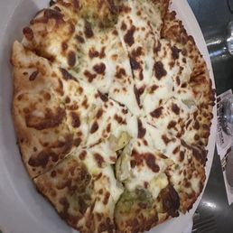 Veggie flatbread pizza with pesto sauce and artichokes