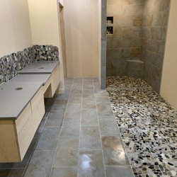 D & D Renovations - River rock and gray large format tile shower