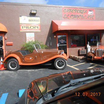 Cafeteria El Chocolate - two cars parked in front of a restaurant - Pizza Near Me - Cape Coral, Florida