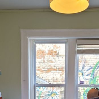 Butter Cafe - a man sitting at a table with a laptop in front of him - New American Near Me - Dayton, Ohio