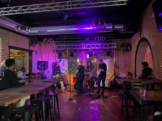 Photo of La Perla Sports Cantina - Glendale, AZ, US. Musicians setting up on stage