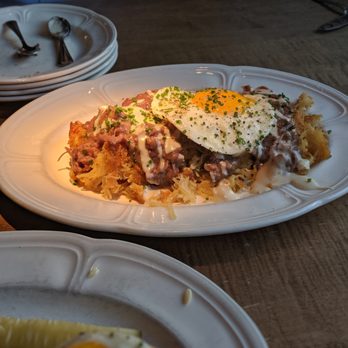 Au Cheval - crispy potato hash with duck heart gravy. Ate some of this with dinner and took the rest home and reheated the next day! delicious & rich! - Bars Near Me - Chicago, Illinois