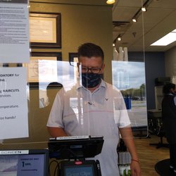 Great Clips - Rito at the register w his mask and sneeze Shield.