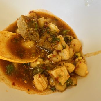 Mi Pueblito - a white bowl of food with a wooden spoon - Mexican Near Me - Walla Walla, Washington Mi Pueblito - a white bowl of food with a wooden spoon - Mexican Near Me - Walla Walla, Washington