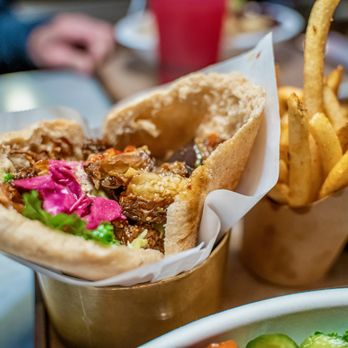 Brassica - a sandwich and french fries on a table - Mediterranean Near Me - Columbus, Ohio