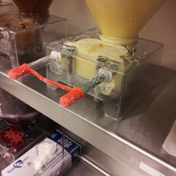 Dunkin' -  a machine that is filling a container with butter - Donuts Near Me - Bessemer, Alabama