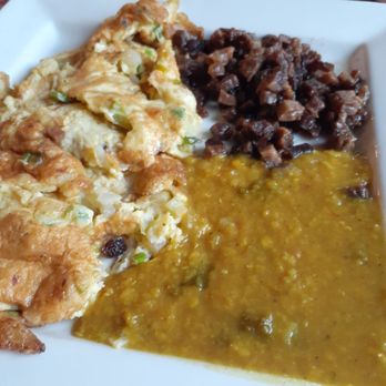 Village - a plate of food on a table - African Near Me - Edmonton, Alberta Village - a plate of food on a table - African Near Me - Edmonton, Alberta