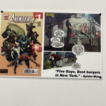 Five Guys - sign from the universe im in the right place - A poster displays Marvel's Avengers characters on the left and a comic strip with Spider-Man on the right, including a quote about burgers. - Burgers Near Me - Bayside, New York