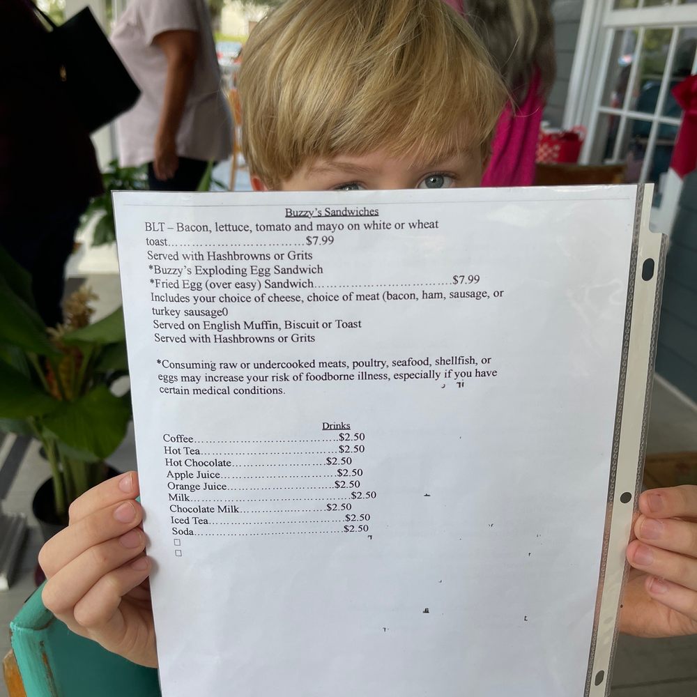 Buzzy's Breakfast Downtown - a child holding a menu - Breakfast & Brunch Near Me - Ocean Springs, Mississippi Buzzy's Breakfast Downtown - a child holding a menu - Breakfast & Brunch Near Me - Ocean Springs, Mississippi