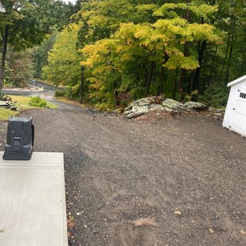 Whitman Restoration - a driveway with a fire hydrant in the foreground - General Contractors Near Me