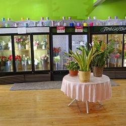 Three coolers full of ready to buy floral bouquets or by the stem fresh flowers.