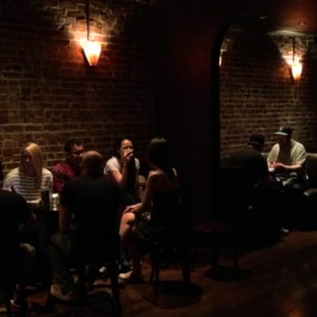 Bootleg Bar - a group of people sitting around a table - Bars Near Me - Brooklyn, New York
