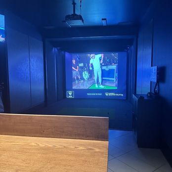 Lounge by Topgolf - a ping - pong table with a television in the background - Sports Bars Near Me - Frisco, Texas Lounge by Topgolf - a ping - pong table with a television in the background - Sports Bars Near Me - Frisco, Texas
