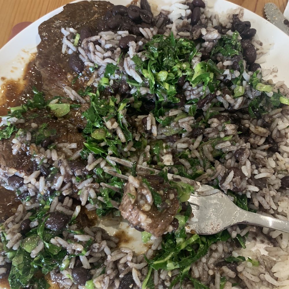 Beef with garlic sauce mixed with white rice, black beans, and collard greens Beef with garlic sauce mixed with white rice, black beans, and collard greens