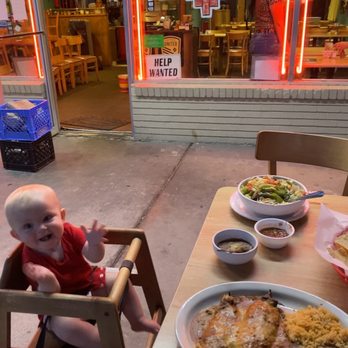 Francisca's - a baby sitting in a high chair in front of a restaurant - Mexican Near Me - Farmington, New Mexico