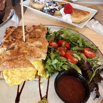 Pineapple Sol - pesto morning press and pancake flight in the back (smores, birthday cake, and strawberry & cream) - Coffee & Tea Near Me - Cary, North Carolina Pineapple Sol - pesto morning press and pancake flight in the back (smores, birthday cake, and strawberry & cream) - Coffee & Tea Near Me - Cary, North Carolina
