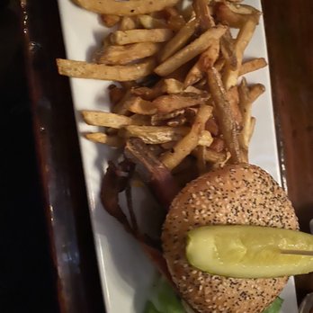 Charity's 1887 Saloon - Burger served on a gluten-free bun with a side of fries - American Near Me - Killington, Vermont