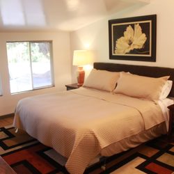 Volcano Lava Lodge Accommodations - Wolfie Suites' Bedroom with a King Size Bed