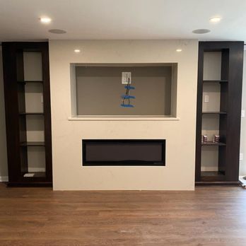 Star Granite & Marble - a fireplace with built in shelvings - General Contractors Near Me - Springfield, Virginia