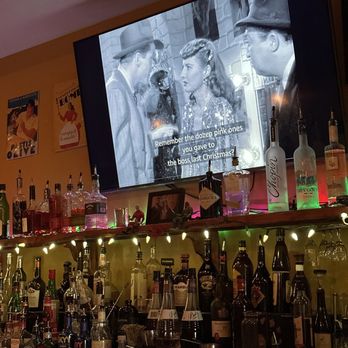 Cafe 1912 - Old movie playing, bar filled with various liquors. - New American Near Me - Memphis, Tennessee Cafe 1912 - Old movie playing, bar filled with various liquors. - New American Near Me - Memphis, Tennessee