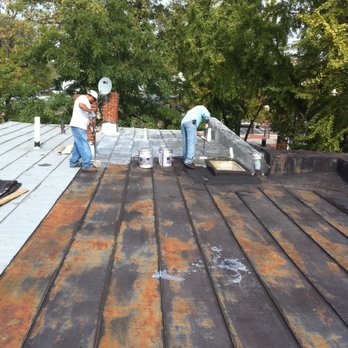 B & W Contracting - Applying fibered aluminum coating to seal seams, stop leaks, and reflect heat - Roofing Near Me