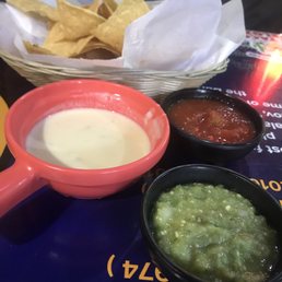Salsa verde, mild salsa, queso, and chips
