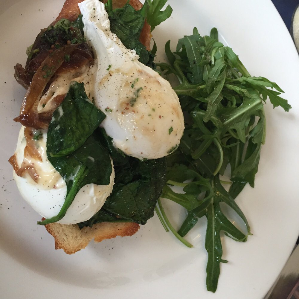 Poached eggs with spinach and carmelised onions on sourdough Poached eggs with spinach and carmelised onions on sourdough