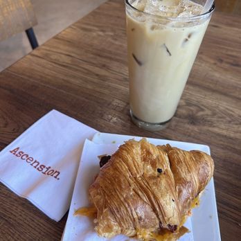 Ascension Coffee - Addison - Iced vanilla latte & breakfast sandwich in croissant - Coffee & Tea Near Me - Addison, Texas Ascension Coffee - Addison - Iced vanilla latte & breakfast sandwich in croissant - Coffee & Tea Near Me - Addison, Texas