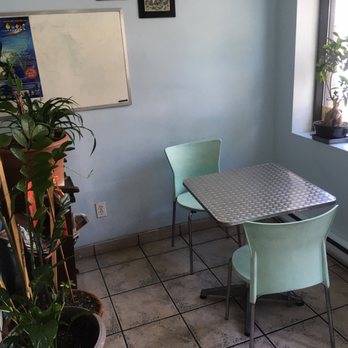 Sandwiches Thai Saigon - a table and chairs in a small room - Thai Near Me - Montreal, Quebec