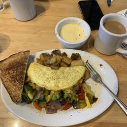 Mom's Kitchen - Veggie & Cheese Omelet, potatoes, sweet bread toast. Hollandaise sauce. Coffee. Senor burrito in background.