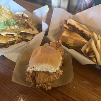 The Pigpen - Left: Brisket nachos Middle: Hot Chicken Slider Right: Brisket Grilled Cheese - Bars Near Me - San Antonio, Texas The Pigpen - Left: Brisket nachos Middle: Hot Chicken Slider Right: Brisket Grilled Cheese - Bars Near Me - San Antonio, Texas