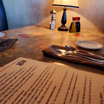 McPhee's Grill - a table with a menu and a lamp - Steakhouses Near Me - Templeton, California McPhee's Grill - a table with a menu and a lamp - Steakhouses Near Me - Templeton, California
