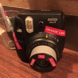 an instax camera on a counter an instax camera on a counter
