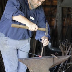 Mabee Farm Historic Site - The blacksmith hard at work
