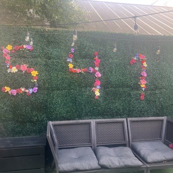 Sultan's Restaurant & Lounge - This photo shows the back patio area . Wonderful display of greenery and floral arrangement on the walls that will never perish. - Mediterranean Near Me - Charleston, South Carolina