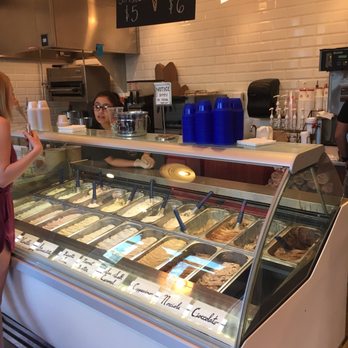 Caffe Gio - a woman standing in front of a display of ice cream - Cafes Near Me - Alpharetta, Georgia