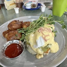 Eggs benny w Avocado, microgreens on biscuit with fried potatoes. Eggs benny w Avocado, microgreens on biscuit with fried potatoes.