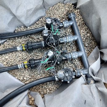 Unswerving Development  - a bunch of hoses laying on the ground - Landscaping Near Me