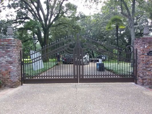 Ornate Iron Gates: Prescission Measured-Tailor-Fit - Custom Iron Fence In Baton Rouge.
There’s no better way to make your house unique and “your own” than with a custom iron fence. Even if you live in a subdivision, you definitely don’t want your home to look cookie cutter. You want it to stand out – in a great way – with curb appeal that makes your neighbors jealous, and down the road when you’re ready to sell your home, makes the offers come rolling in!

Forrest Scott Fencing is a locally owned custom iron fence contractor serving metro Baton Rouge. Call us today for a free estimate!

The Forrest Scott Fencing Difference
Custom iron fences are actually a Louisiana tradition. From the beautiful Fleur de Lis designs that decorate the Old State Capitol, to the intricate designs you’ll find in New Orleans’ French Quarter, for generations Southern Louisiana homeowners have recognized the intrinsic value of installing customized iron fences along their property lines.

Let your home express your family’s individualized personality and trust us to come up with a design that will wow you – and everyone who passes by your home.

Why Choose A Custom Iron Fence?
As a family-owned and operated business, we pour our hearts into working with Southern Louisiana families on designing a custom fence that will perfectly accent their Baton Rouge, Greenwell Springs, Central, Denham Springs or Prairieville home. Our custom iron fence process is unique and thorough, and it all starts with you!

When You Choose Us To Create A Custom Iron Fence For You, We Will:
Come to your home to perform measurements, including verifying your property lines and checking with Louisiana One Call before digging commences so we know we don’t inadvertently interfere with any unknown pipelines.

Interview you about your design preferences and styles so we can come up with the perfect custom iron fence for you.

Prepare professional AutoCAD computerized drawings of your custom fence so you can review every aspect of it.

Once approved, fabricate the fence on our site – we won’t outsource any part of the design process to a company that you haven’t met and that hasn’t gained your trust, with the exception of the application of the powder coat as a finishing touch.

Install your fence at your home site with professionalism and quality in mind. In fact, we provide a lifetime guarantee on the placement of your fence!

Never Out Of A Box Or Recycled Designs
When we say we design custom iron fences, we mean just that – all of our fabrication are unique, tailor made and custom. We don’t give you an “out of the box” design or recycle designs we’ve used with previous customers. Sure, you may get some inspiration from our previously completed projects gallery, but we realize that every home, and customer is unique and as such, their custom fences are, too.

Call Us Today For A Quote
If you’re looking to add value to your home and make it stand out, there’s no better way to do so than with a custom iron fence. Call us today to get a quote on the design, fabrication and installation process. We can be reached in Baton Rouge at (225) 667-9997.