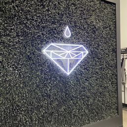  a neon sign of a diamond