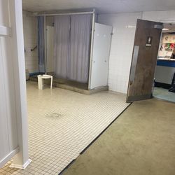 Entrance to showers that look more like out houses