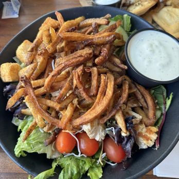 Stack'd - House salad with chicken that comes with French fries on top and dressing on the side. - American Near Me - Pittsburgh, Pennsylvania