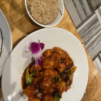 Wild Ginger - a plate of food with rice and a bowl of brown rice - Sushi Bars Near Me - Palm Coast, Florida