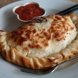 Myrts - Canadian Panzarotti $9. Hugh in portion.  See fork as size reference