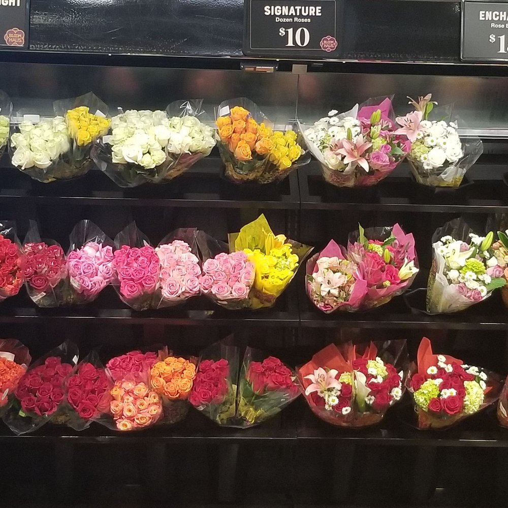 a display of flowers in a grocery store a display of flowers in a grocery store