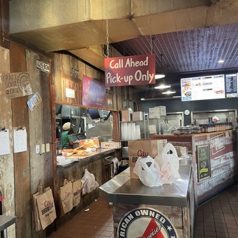 City Barbeque - Counter area - Counter area at a restaurant with a sign for call ahead and pick-up only, and various bags and items on the counter. - Barbeque Near Me - Powell, Ohio