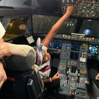 American Airlines - Amazing Captain of American Airlines in his cockpit & curious young passenger. - Airlines Near Me - Norfolk, Virginia American Airlines - Amazing Captain of American Airlines in his cockpit & curious young passenger. - Airlines Near Me - Norfolk, Virginia