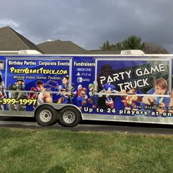 Party Game Truck - The outside of the truck. It has two large screens that can be used for playing games outside.