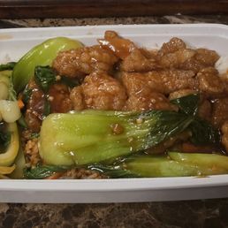Sliced fish with vegetables on rice